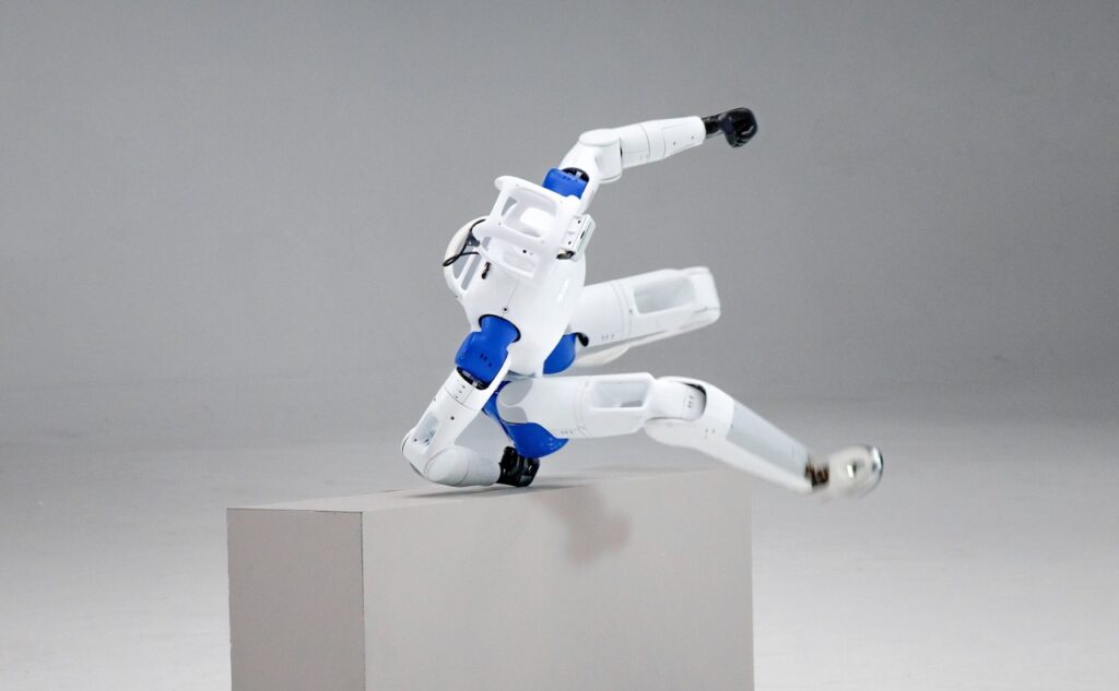 Humanoide RoboParty RP1 se apoiando em um bloco ao transpor obstáculo